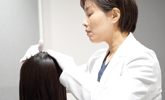 女性医師の頭皮触診